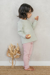 Side view of a child wearing the Avauma Peach Glow Set in Soft Sage – crafted from soft materials with a comfortable fit ideal for everyday play